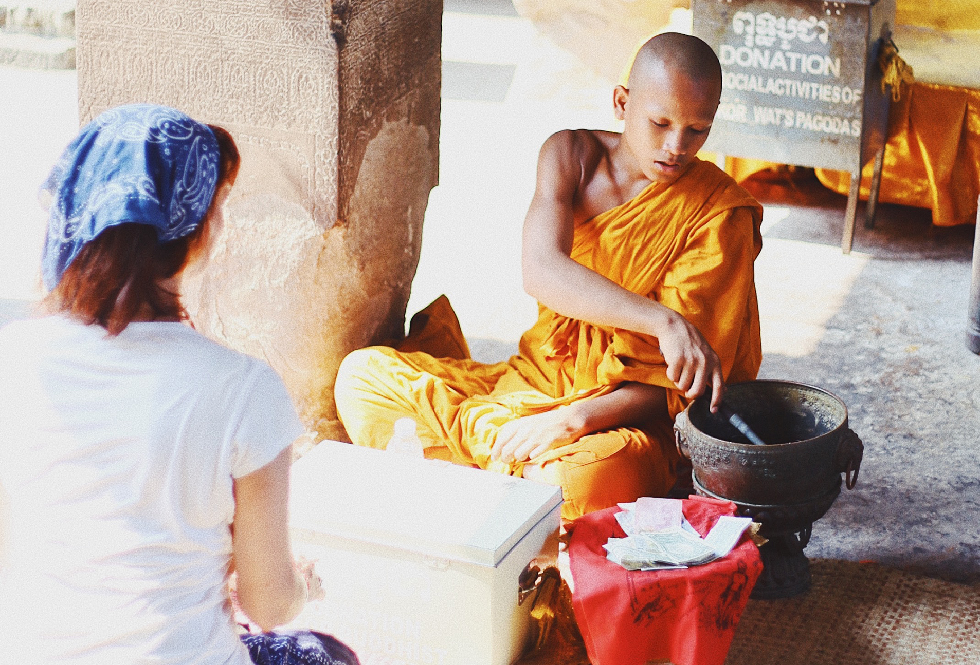 Buddhist monk sits with tourist.