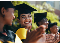 Students graduating and smiling