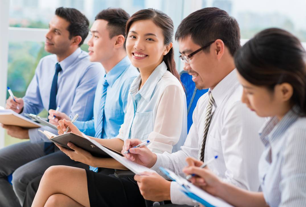 five students taking notes