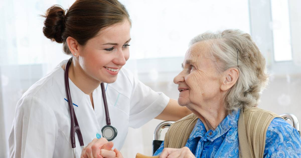 nurse with elderly lady smiling