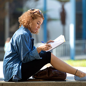 Female student studying outdoors.
