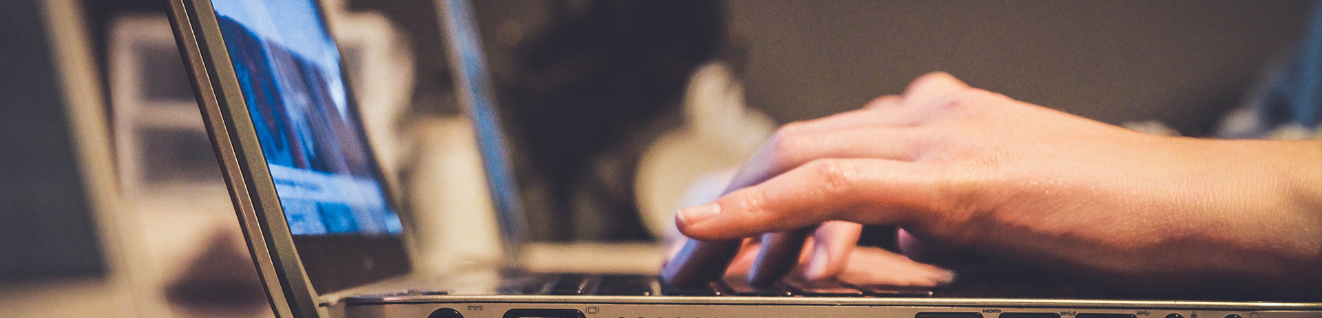 Student typing on laptop. 