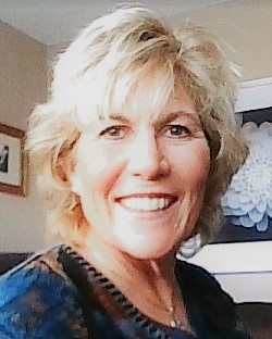 lady with bolde hair smiling