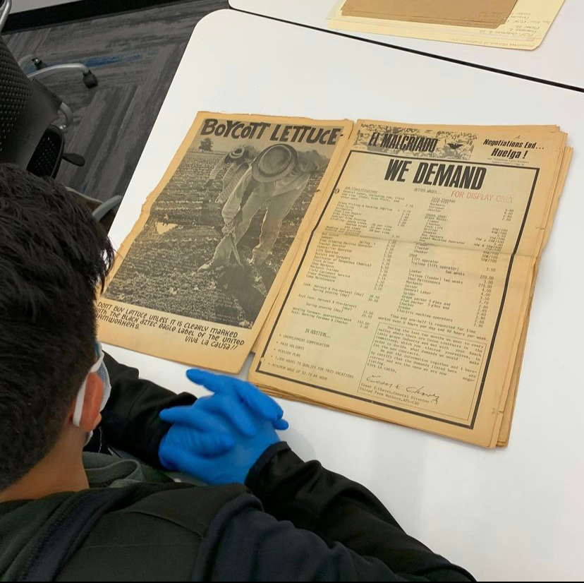 student examining old faded document