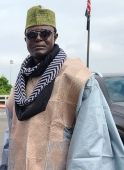 Black man in a traditional outfit with cool sunglasses on