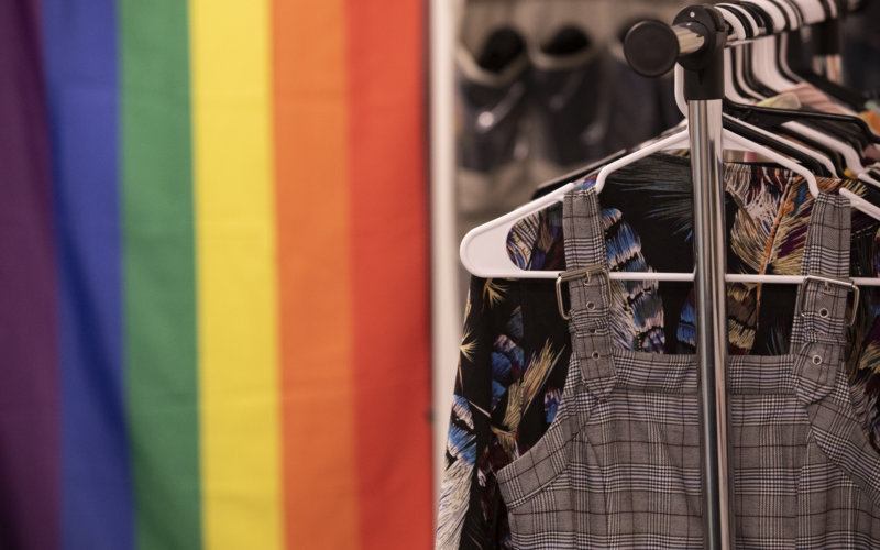 Gender-Affirming Closet clothing rack with pride flag in background