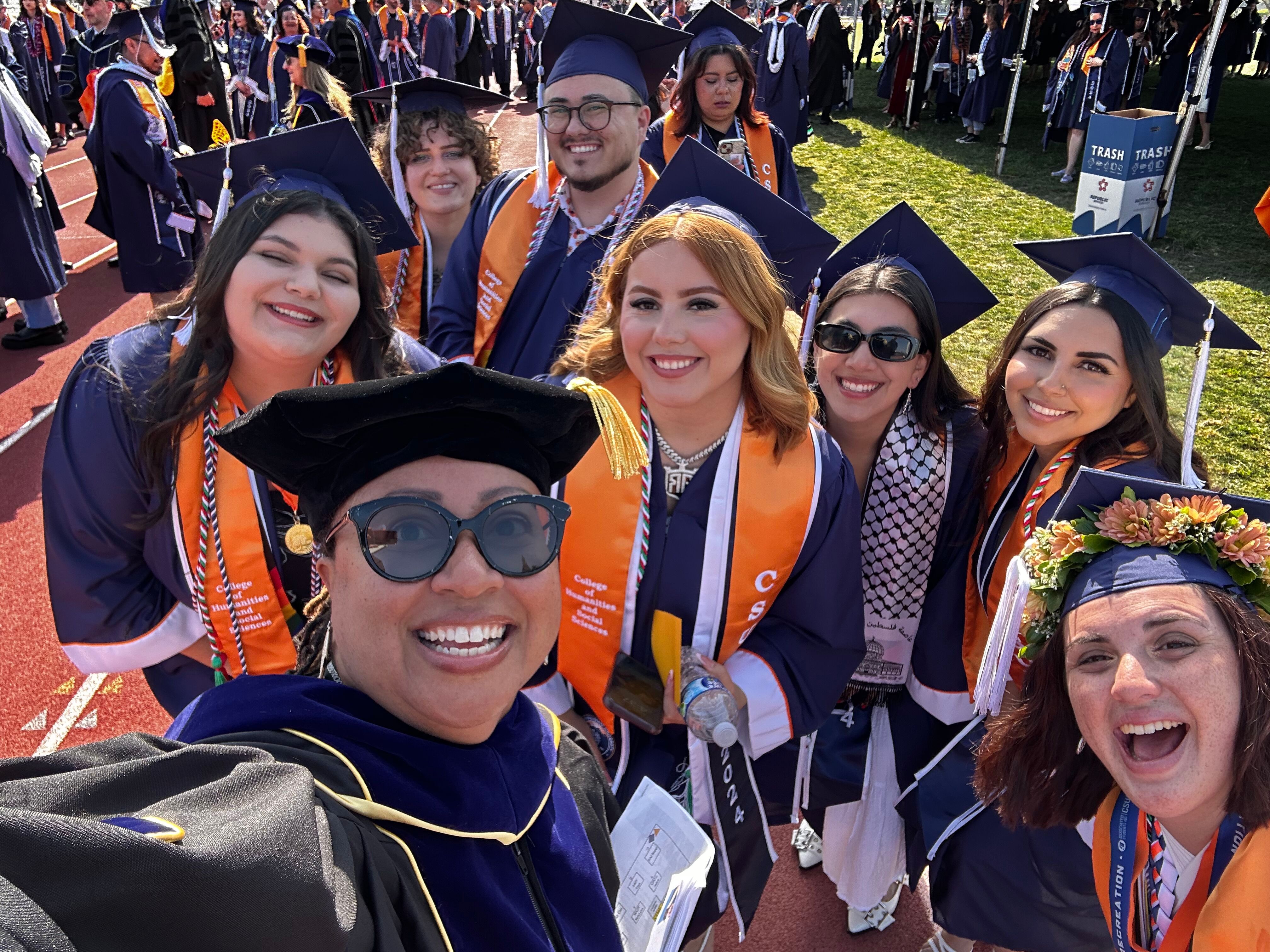 Dr. Lee and students at 2025 Commencement
