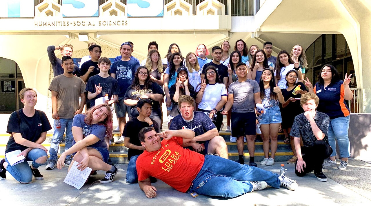 Group of HSS Theme housing students posing outside.